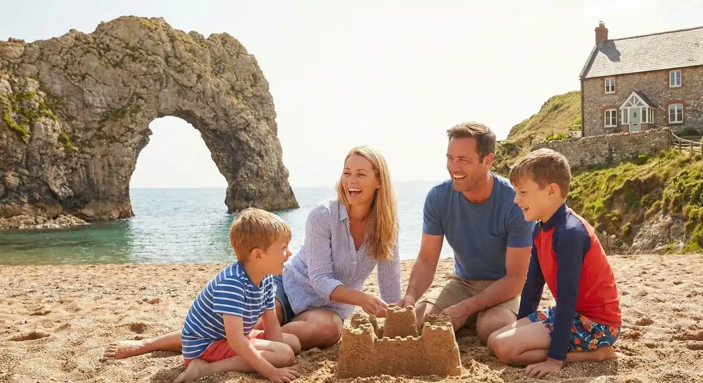Family enjoying a sunny day at Durdle Door on the Dorset Jurassic Coast — holiday lets managed by Full Bed Hosts
